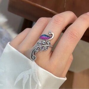 Elegant Silver Peacock Ring with Purple Accents.